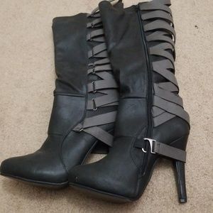 Knee high heeled boots with decorative strap